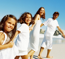 image of family with white clothes on beach
